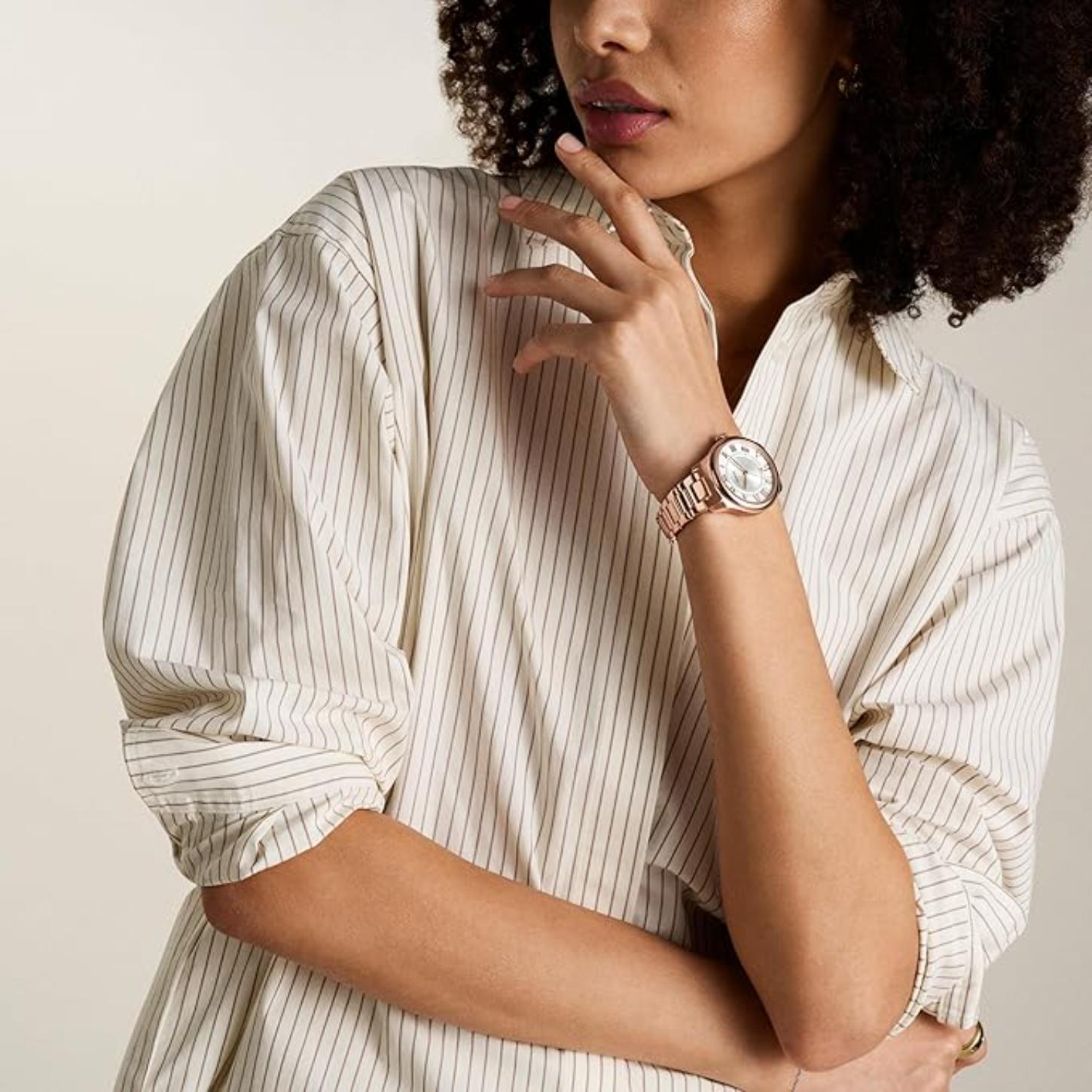 Fossil Gilmore ES5420 with silver dial, rose gold-tone case, and matching bracelet worn on the wrist in an elegant everyday style.