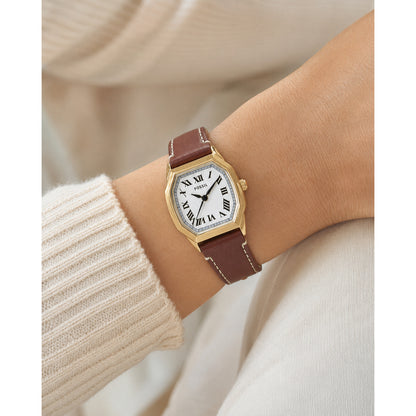 Fossil Harlow ES5364 with a white dial, black Roman numeral hour markers, gold-tone case, and brown leather strap with contrast stitching worn on the wrist.
