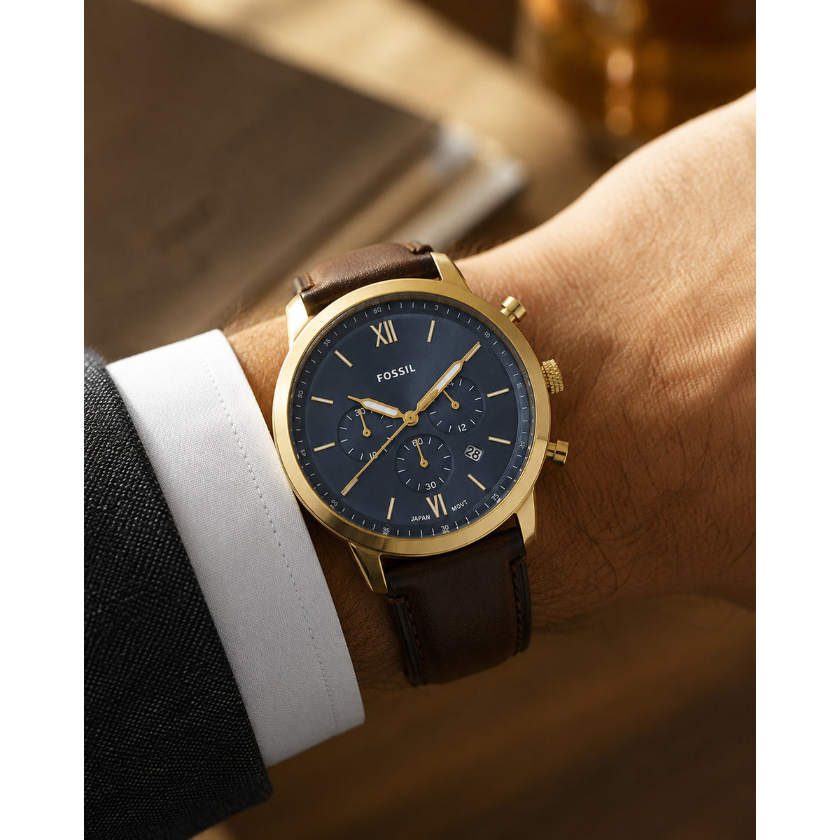 Fossil Neutra FS6162 with a blue chronograph dial, gold-tone case and accents, and brown leather strap worn on the wrist.