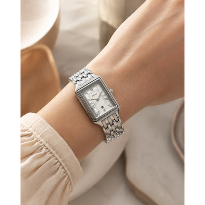 Fossil Raquel ES5221 with a silver dial, Roman numeral hour markers, rectangular silver-tone case, date window, and matching bracelet worn on the wrist.