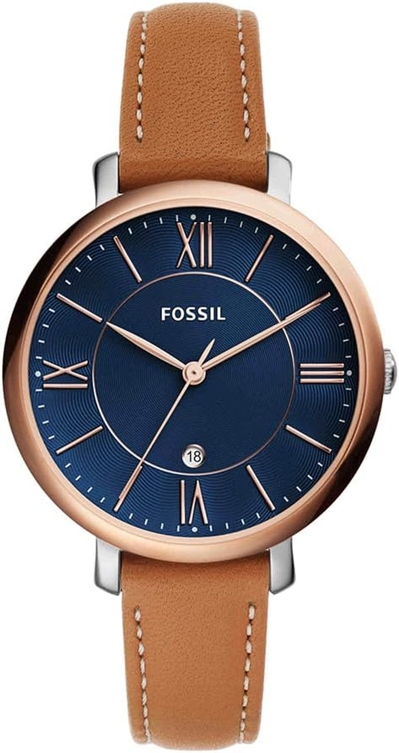 Reloj Fossil analógico con esfera azul, números romanos y correa de piel marrón.