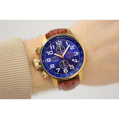 Invicta 3329 chronograph worn on the wrist with blue dial, large white Arabic numerals, gold-tone case and brown leather strap.