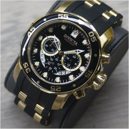 Invicta 6981 chronograph with black dial, three subdials, gold-tone stainless steel case, black bezel with gold markers and black strap with gold center links.