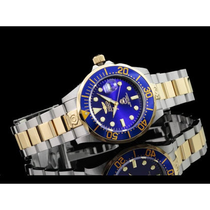 Invicta Grand Diver 3049 automatic dive watch with blue dial, blue bezel, and two-tone stainless steel bracelet displayed on a reflective black surface.