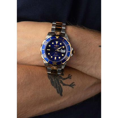 Invicta Grand Diver 3049 automatic dive watch with blue dial, blue bezel, and two-tone stainless steel bracelet worn on the wrist.