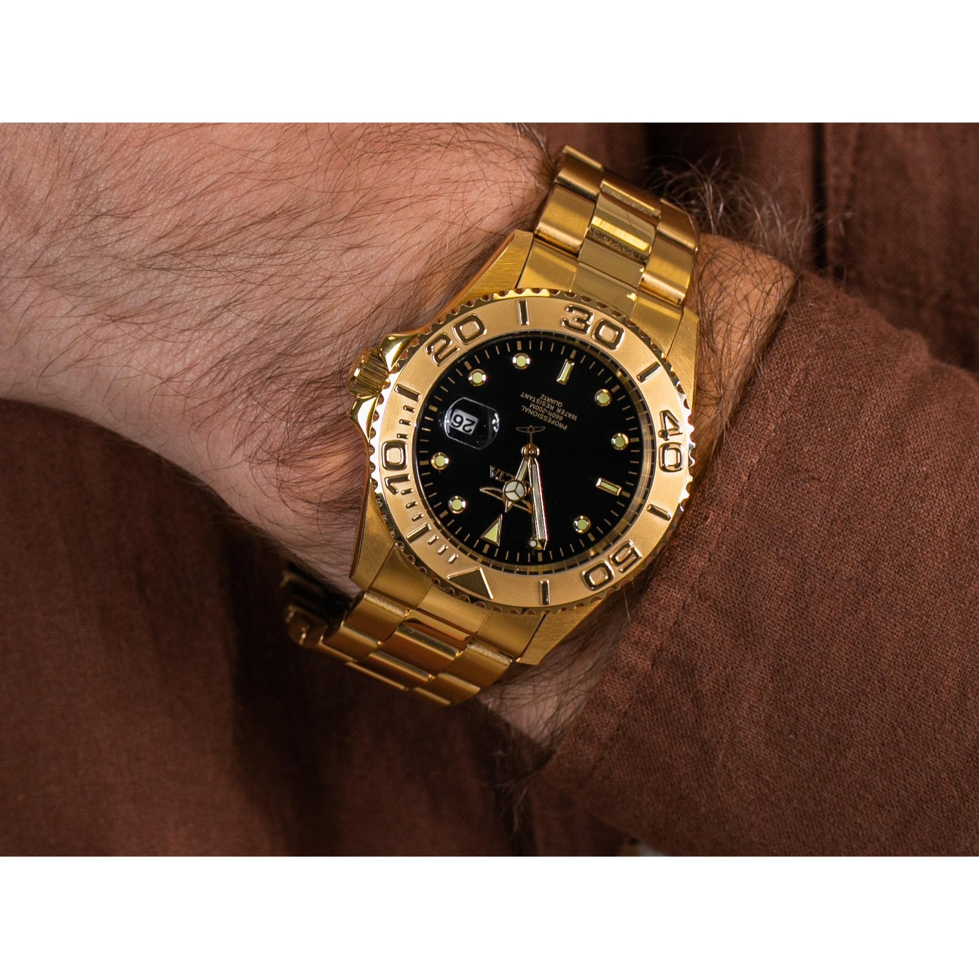 Invicta Pro Diver 29946 dive watch worn on wrist with black dial, gold-tone unidirectional bezel and gold-tone stainless steel bracelet.