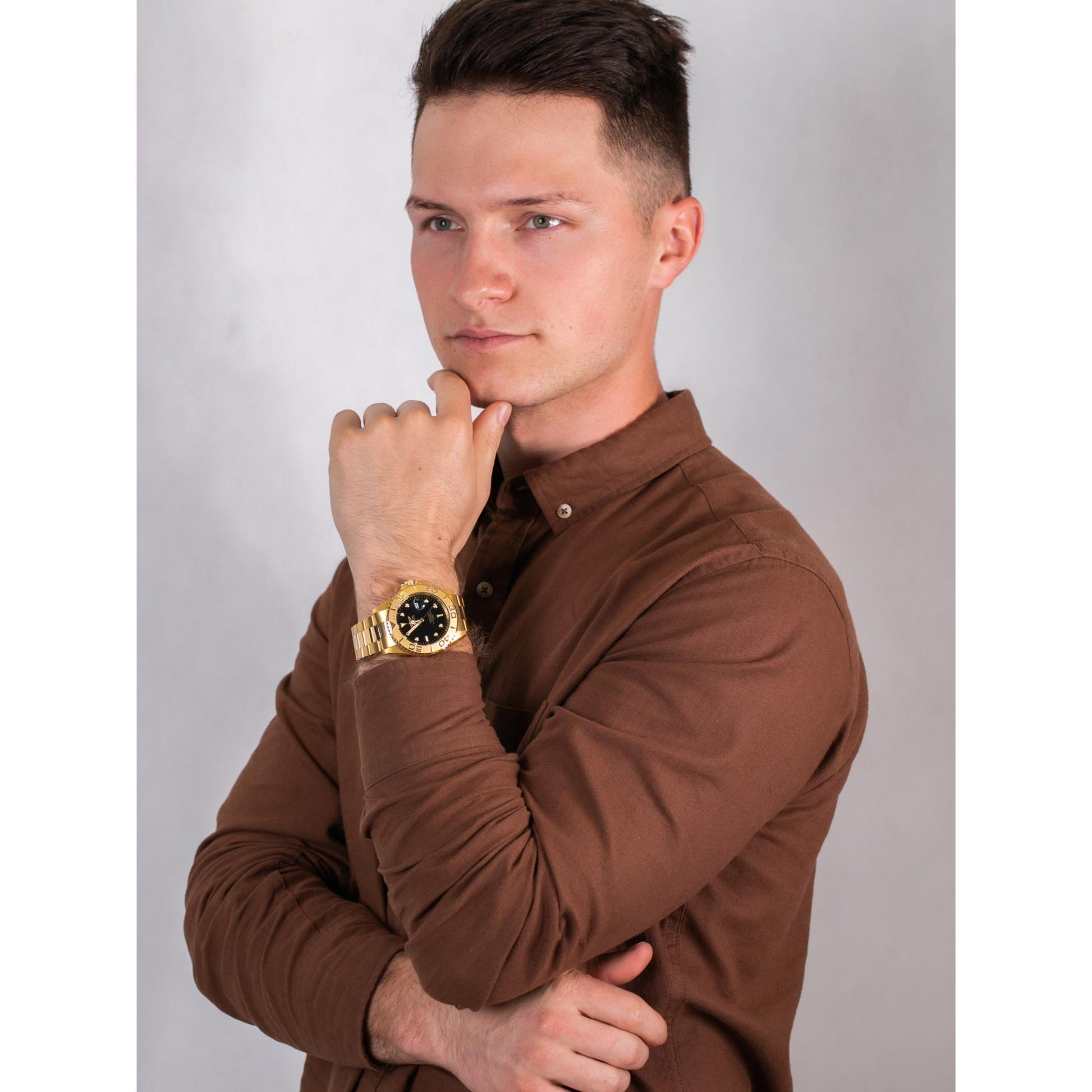 Invicta Pro Diver 29946 gold-tone dive watch with black dial worn on wrist in lifestyle portrait setting.