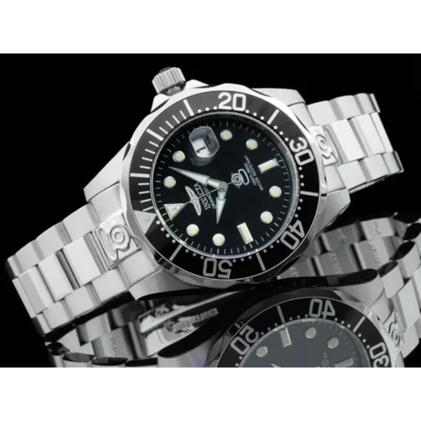 Invicta Pro Diver 3044 automatic dive watch with black dial, luminous markers and stainless steel bracelet displayed in reflective studio lifestyle setting.
