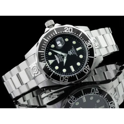 Invicta Pro Diver 3044 automatic dive watch with black dial, luminous markers and stainless steel bracelet displayed in reflective studio lifestyle setting.
