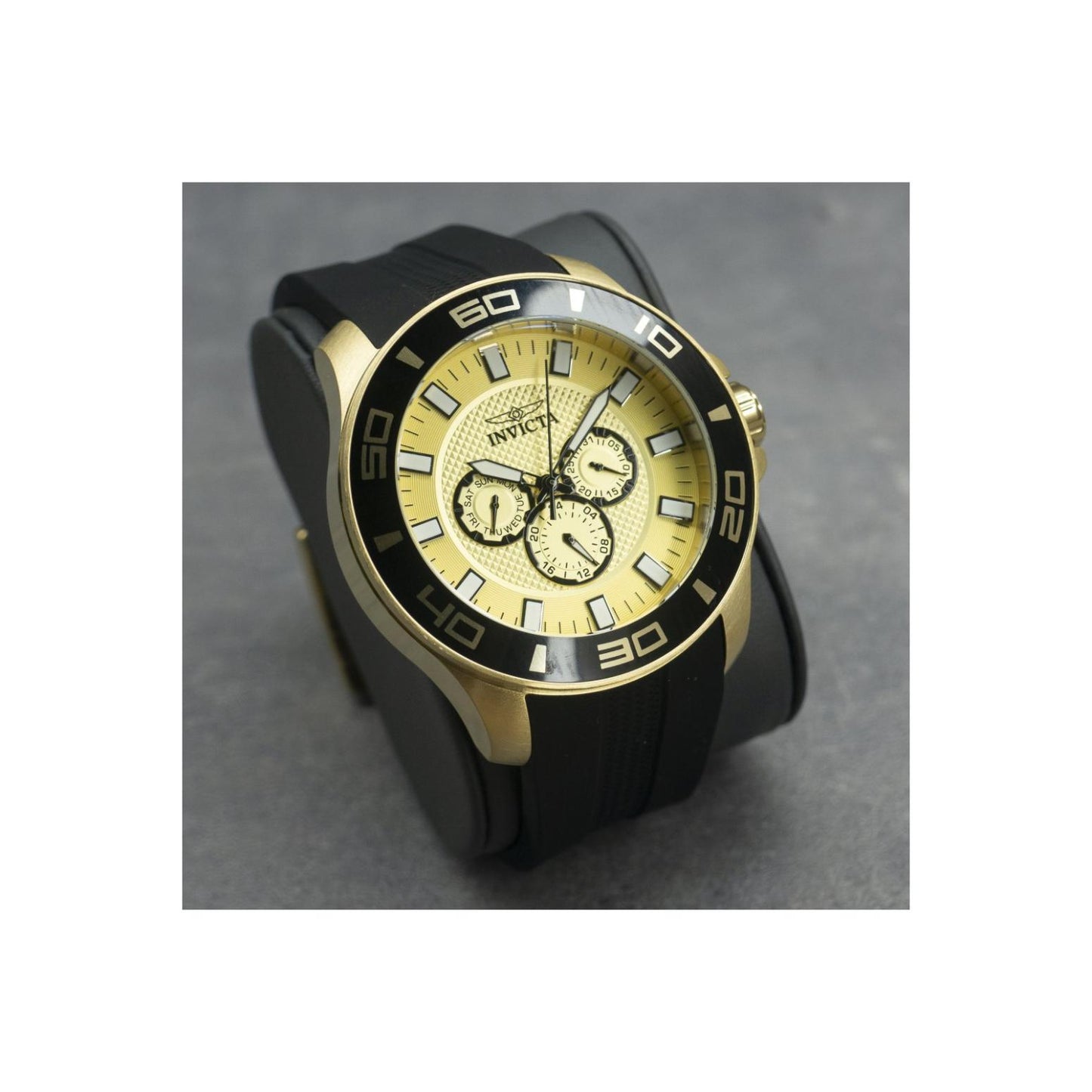 Invicta Pro Diver 35742 chronograph watch with gold-tone dial, black bezel, oversized gold-tone case, and black silicone strap shown in an angled display view.