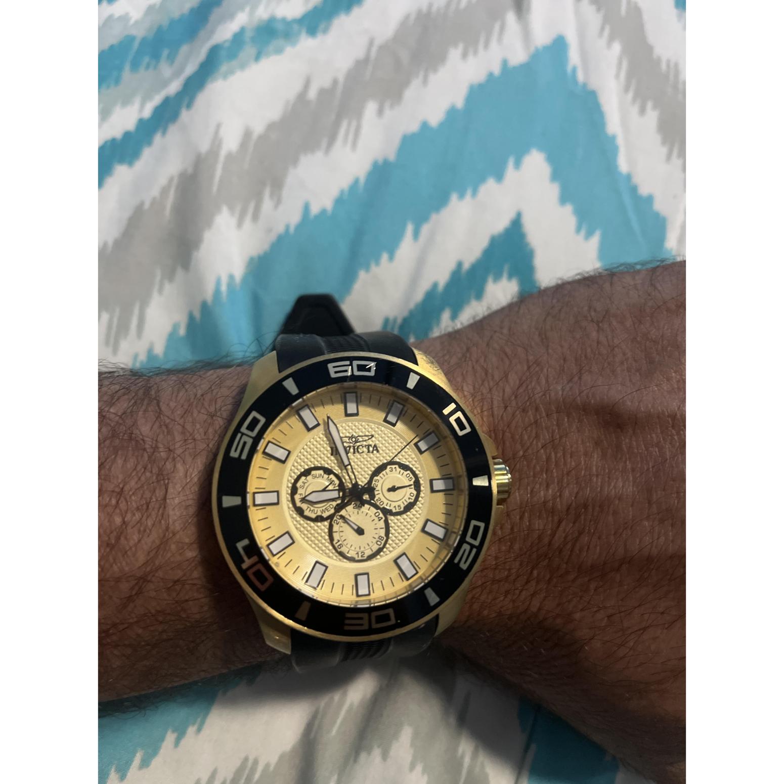 Invicta Pro Diver 35742 chronograph watch with gold-tone dial, black bezel, and black silicone strap worn on the wrist.