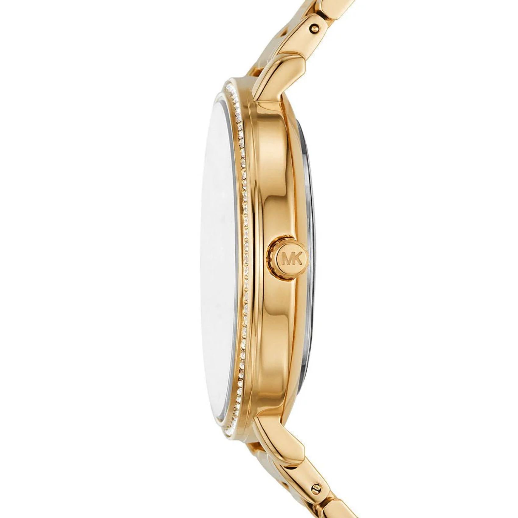 Michael Kors women’s watch with slim gold-tone case, crystal-set bezel and engraved crown shown in side profile.