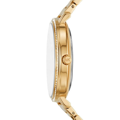 Michael Kors women’s watch with slim gold-tone case, crystal-set bezel and engraved crown shown in side profile.