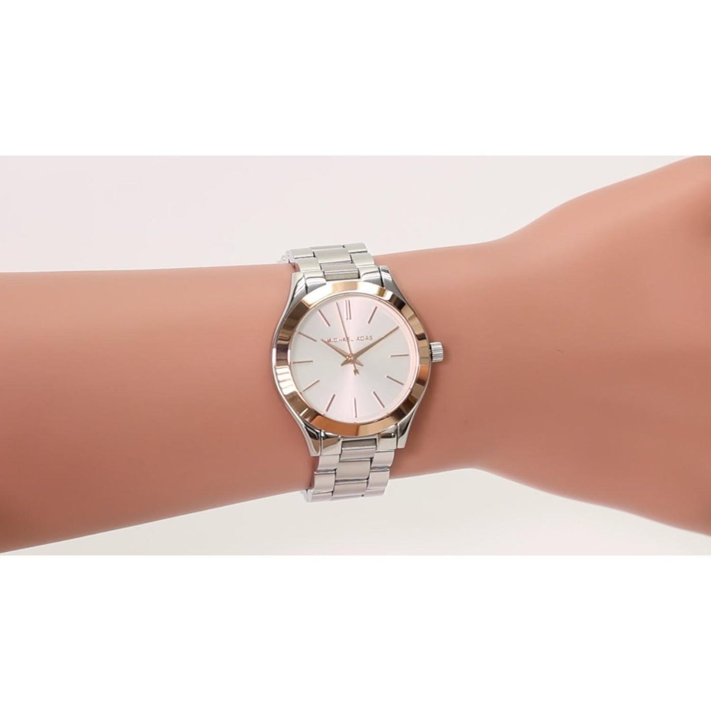 Michael Kors MK3514 Mini Slim Runway women’s watch worn on wrist with white dial, rose gold-tone bezel accents and silver-tone stainless steel bracelet.