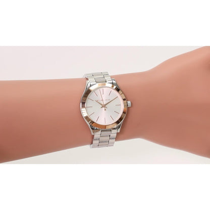 Michael Kors MK3514 Mini Slim Runway women’s watch worn on wrist with white dial, rose gold-tone bezel accents and silver-tone stainless steel bracelet.