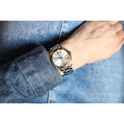 Michael Kors MK3514 Mini Slim Runway women’s watch worn on wrist with white dial, rose gold-tone bezel accents and silver-tone stainless steel bracelet.
