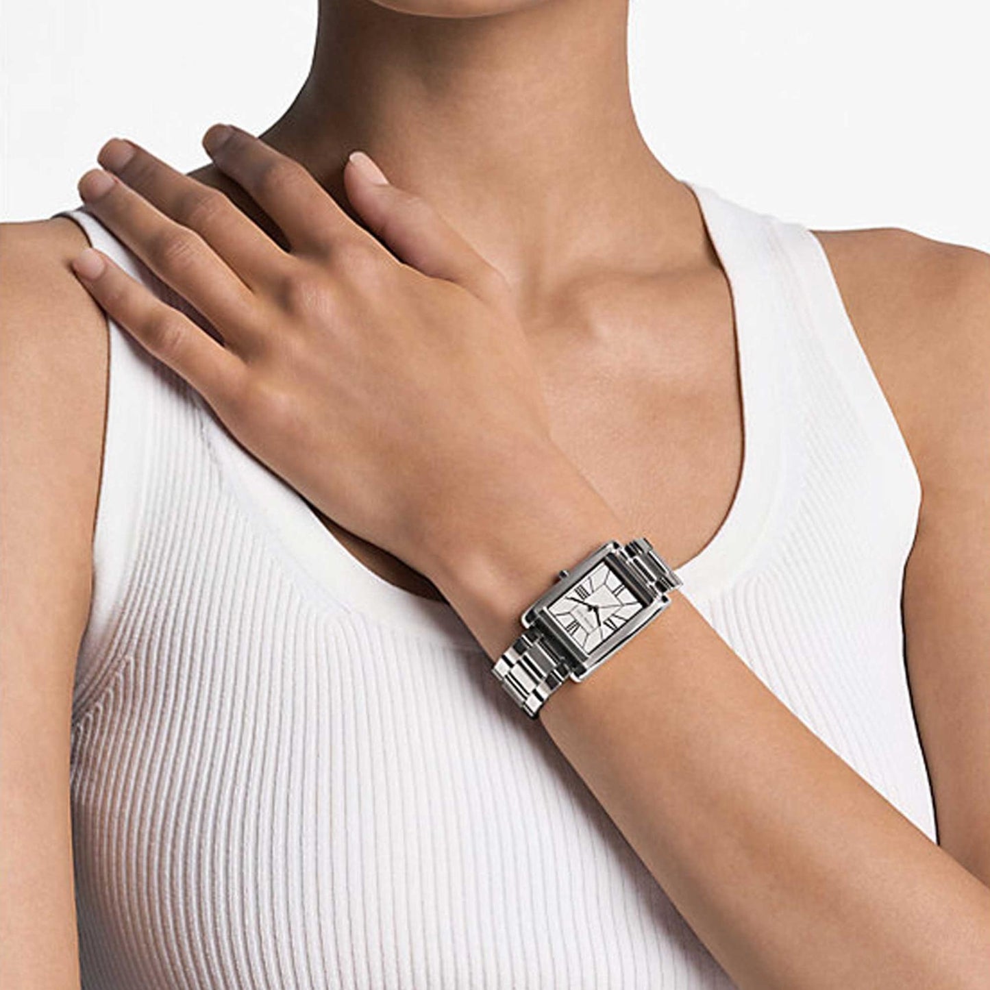Michael Kors MK4906 Essex women’s watch worn on wrist with rectangular silver-tone dial, Roman numeral markers and stainless steel bracelet.