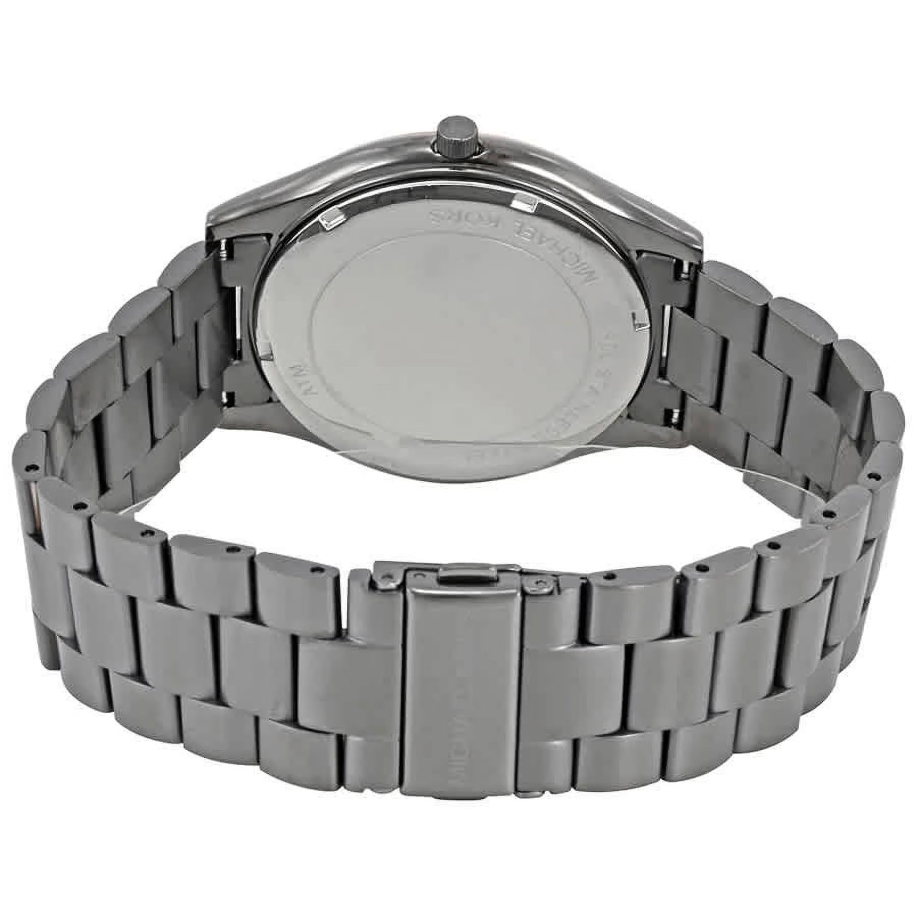 Michael Kors MK8576 with stainless steel caseback, gunmetal link bracelet and fold-over clasp with engraved logo.