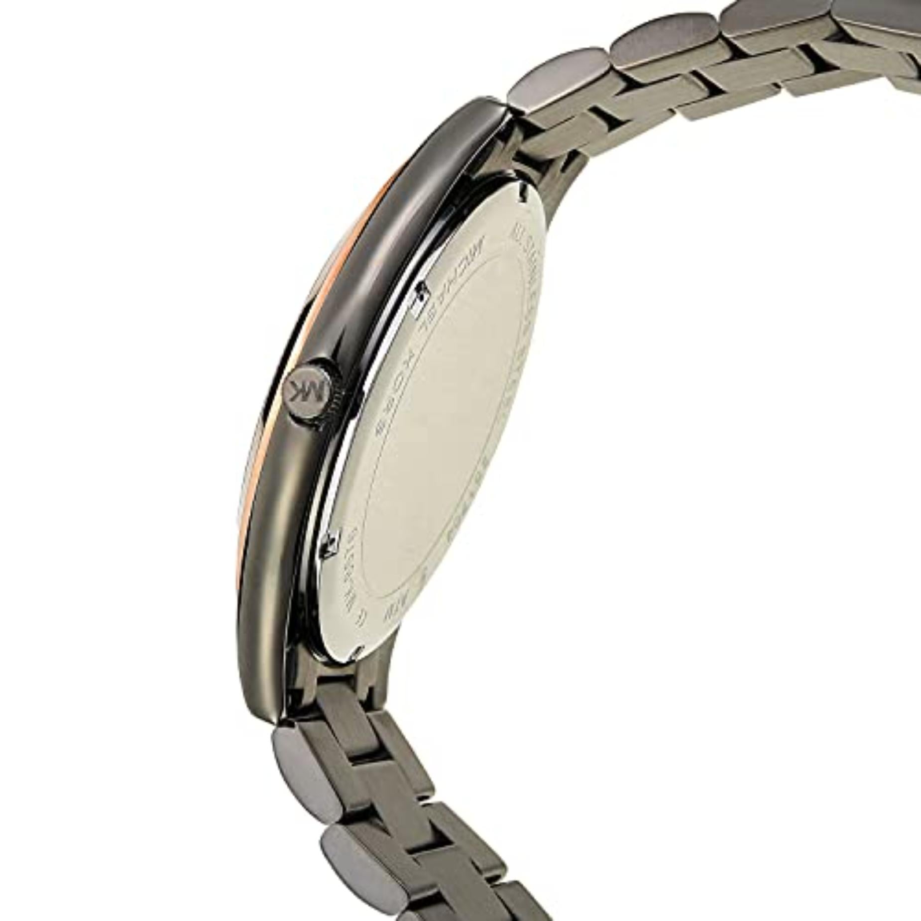 Michael Kors MK8576 with gunmetal stainless steel case, engraved crown, stainless steel caseback and matching link bracelet shown in angled rear profile.