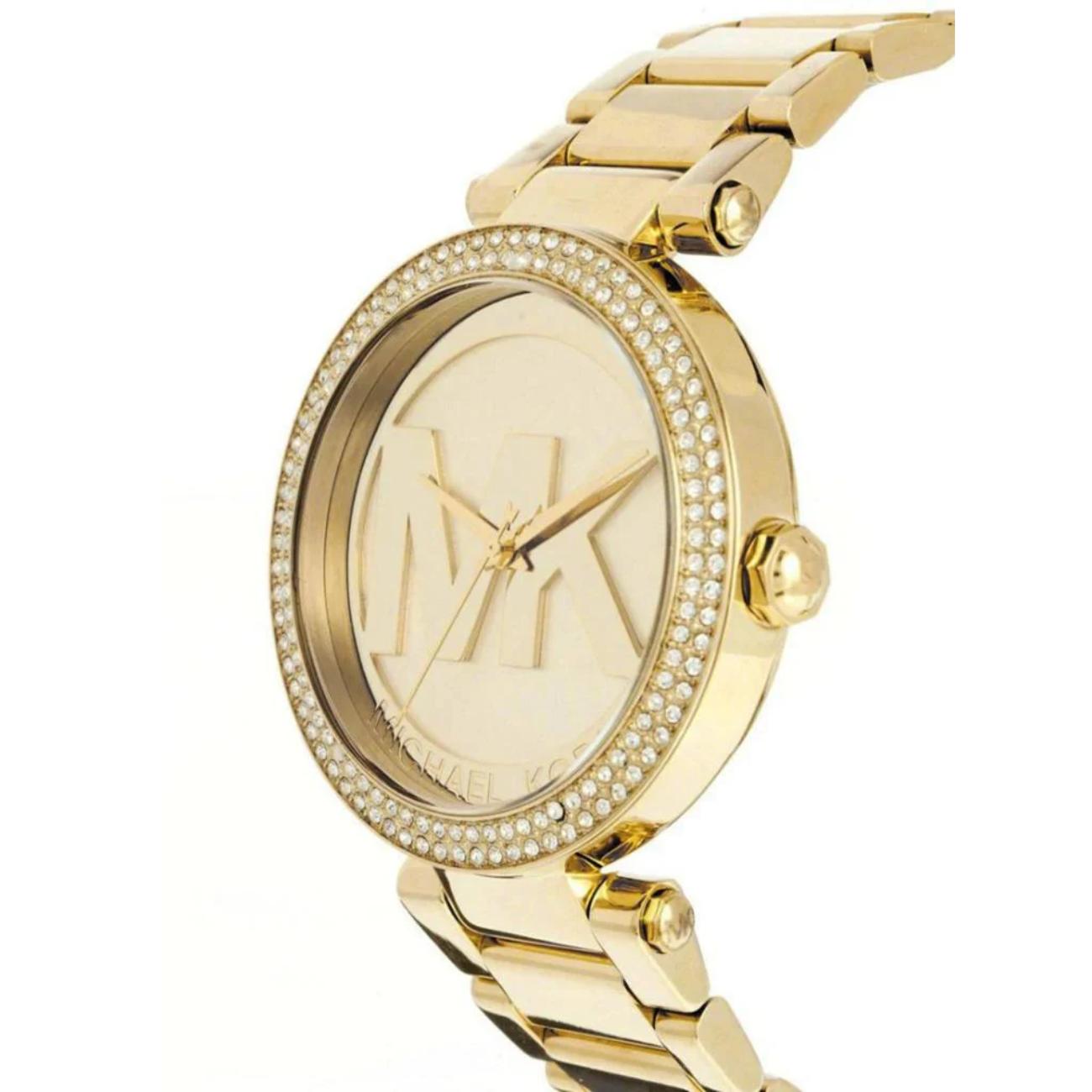 Michael Kors Parker MK5784 angled view showing the gold-tone case, crystal-set bezel, oversized MK logo dial, and gold-tone stainless steel bracelet.