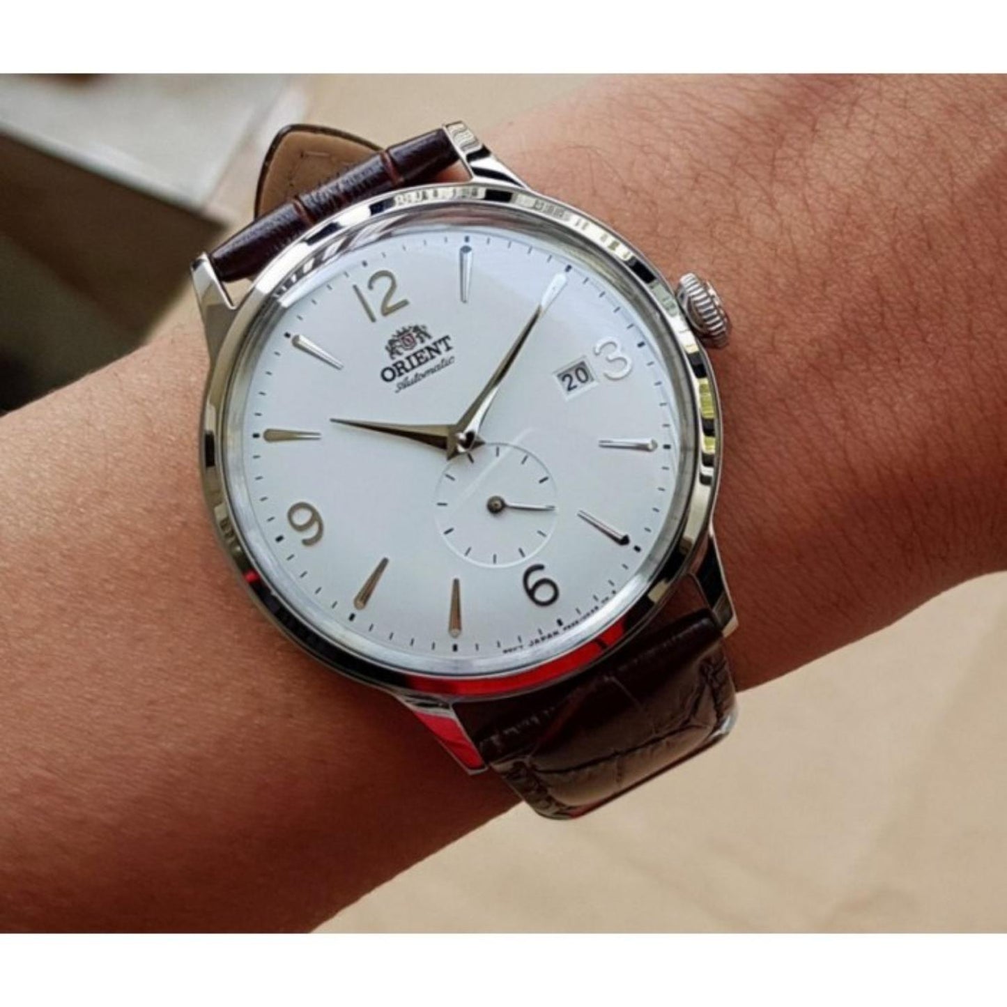 Orient Bambino Small Seconds RA-AP0002S10B automatic dress watch with white dial and brown crocodile-pattern leather strap worn on the wrist.
