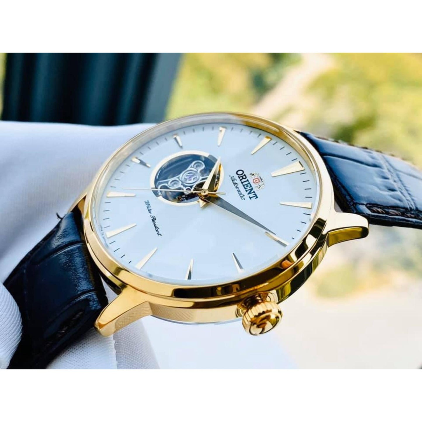 Orient Esteem II Open Heart FAG02003W0 close-up view showing the white open-heart dial, gold-tone case, and brown crocodile-pattern leather strap.
