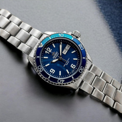 Orient Mako 3 RA-AA0818L19B automatic dive watch with blue dial, blue unidirectional bezel and stainless steel bracelet displayed in close-up lifestyle setting.