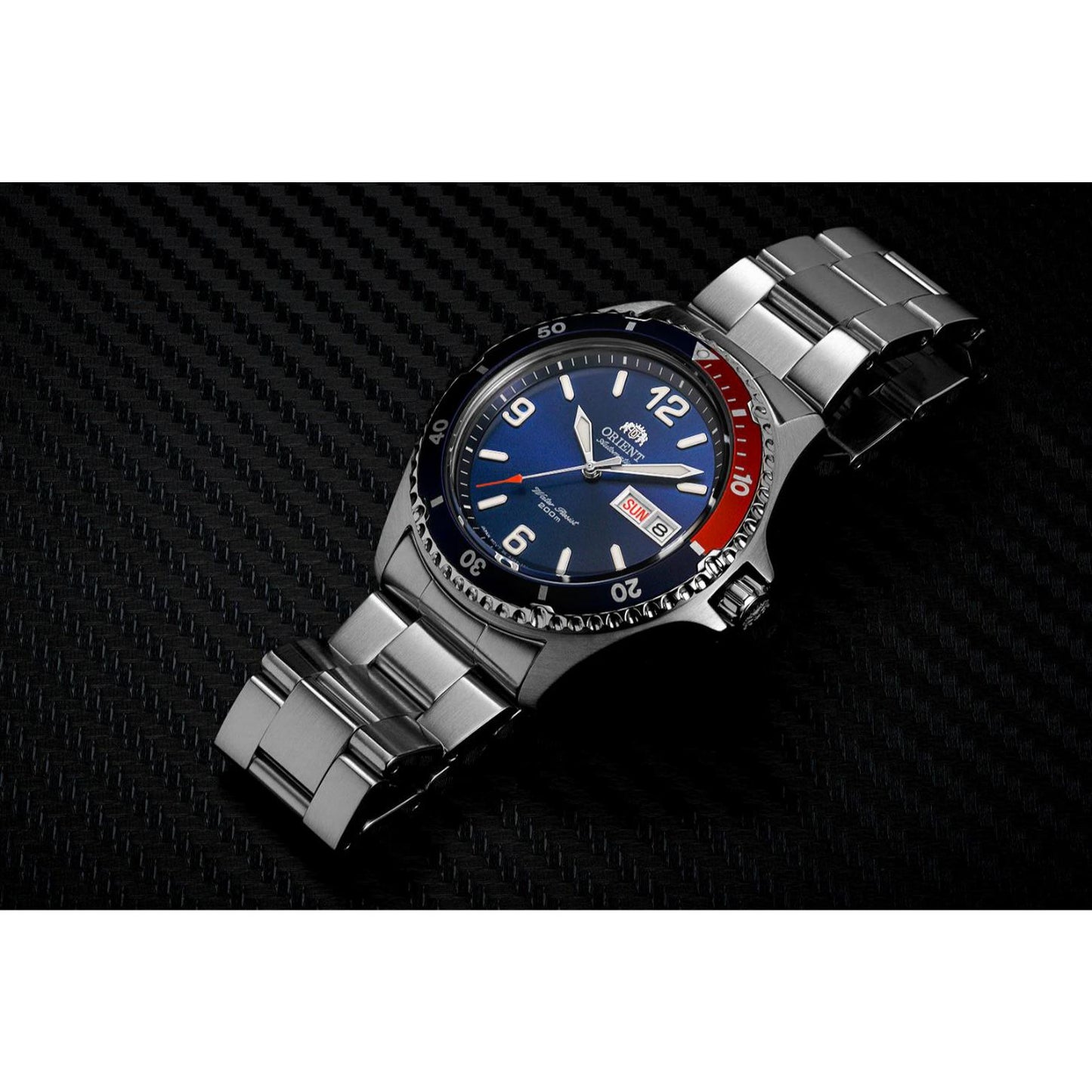 Orient Mako II AA02009D automatic dive watch with blue dial, Pepsi-style red and blue bezel and stainless steel bracelet displayed in dark lifestyle setting.
