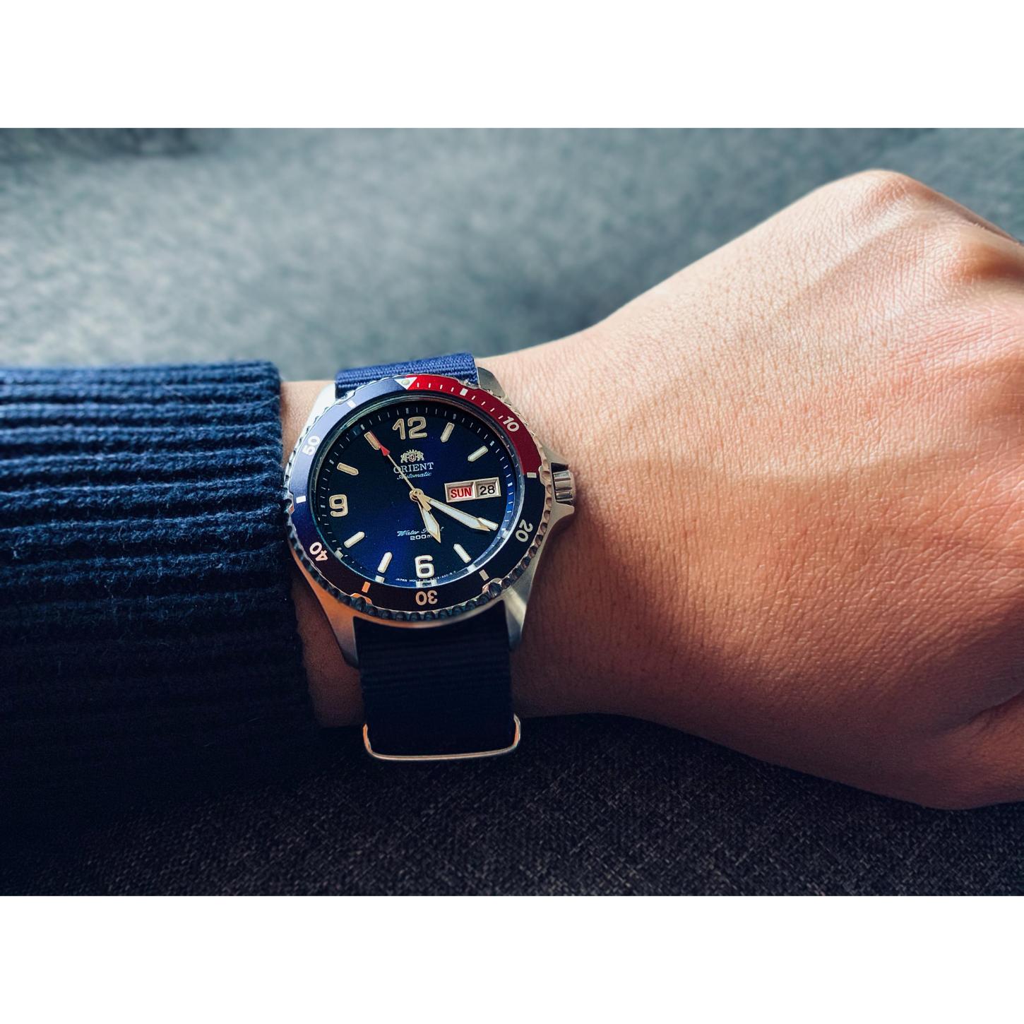 Orient Mako II AA02009D automatic dive watch worn on wrist with blue dial, Pepsi-style bezel and blue NATO strap.