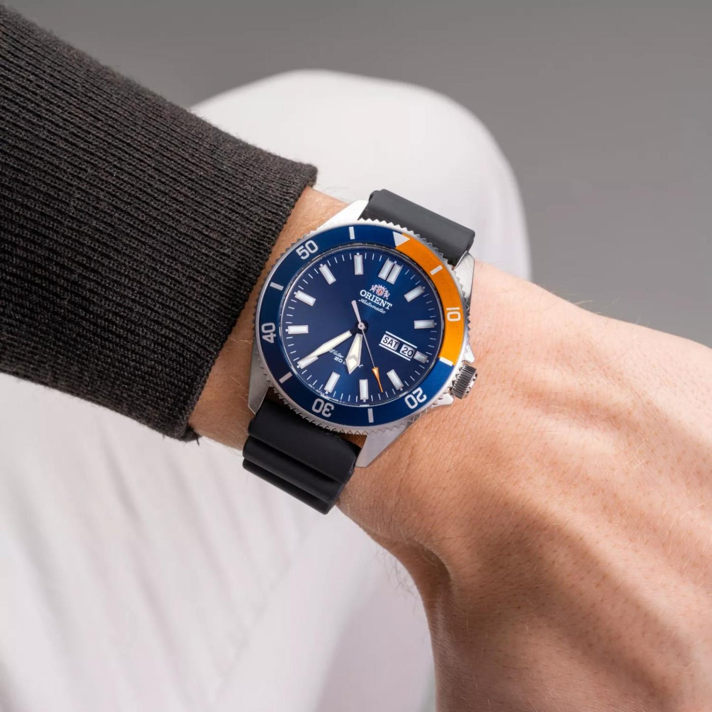 Orient RA-AA0916L19B automatic dive watch with blue dial, blue and orange bezel, and black rubber strap worn on the wrist.
