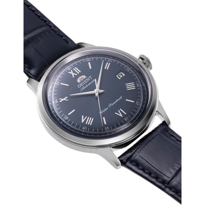 Orient RA-AC0024L30B automatic dress watch with blue sunburst dial, silver-tone case, and blue crocodile-pattern leather strap shown in an angled view.