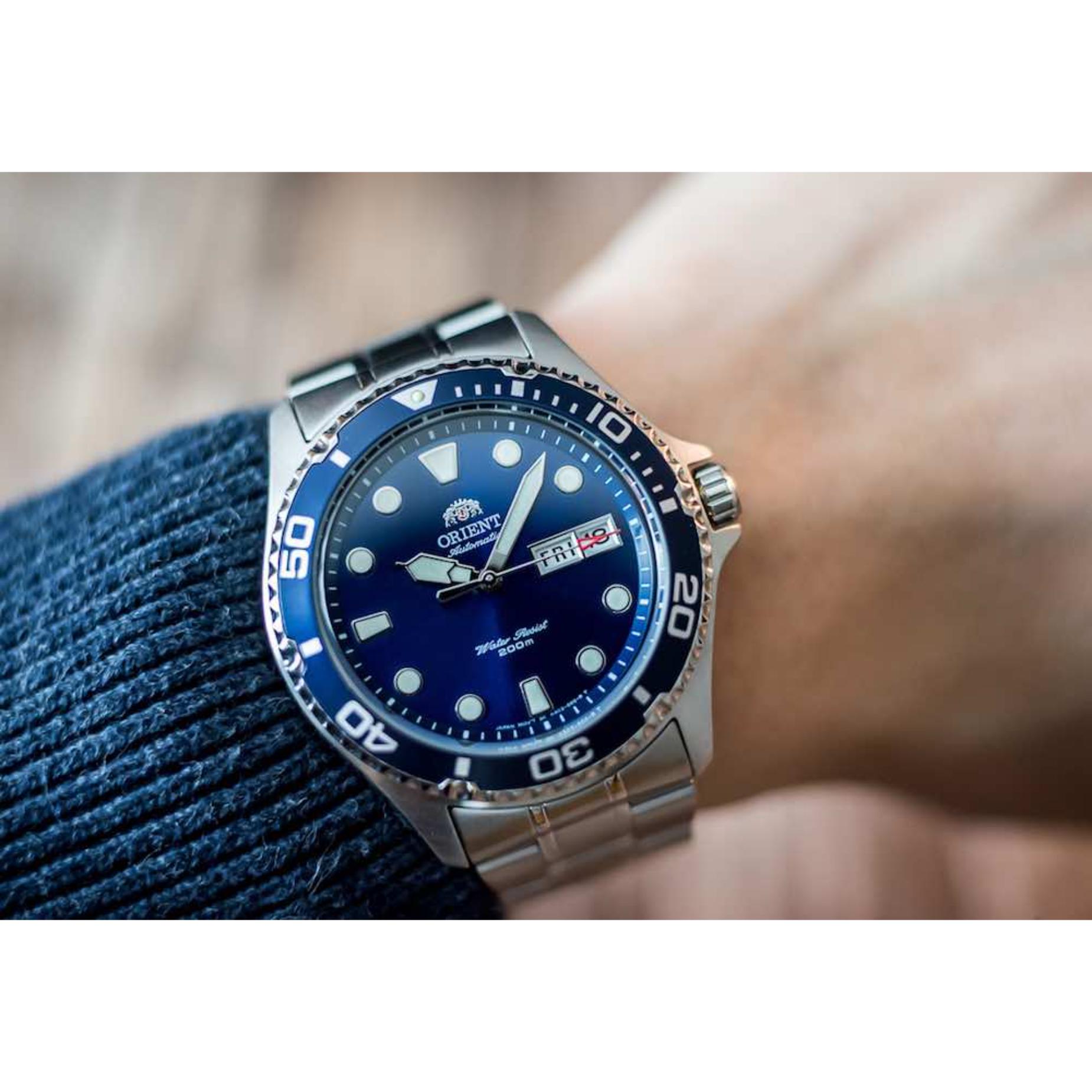 Orient Ray II FAA02005D9 automatic diver watch with blue dial, blue rotating bezel, and stainless steel bracelet worn on the wrist.
