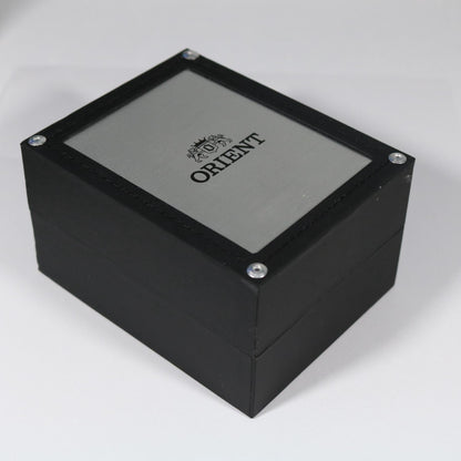 Orient watch presentation box with black wooden exterior, brushed metal lid panel, and Orient logo branding on top.