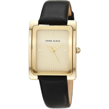 Reloj Anne Klein AK/2706CHBK con caja rectangular dorada y correa negra de piel, esfera dorada minimalista, vista frontal.