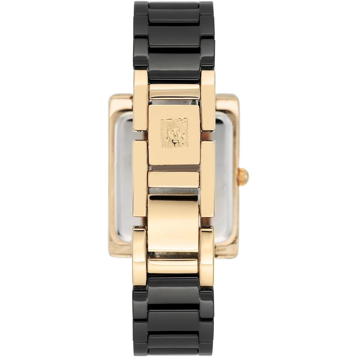 reloj Anne Klein AK/2952BKGB con caja rectangular dorada, esfera negra y brazalete metálico negro visto en ángulo lateral
