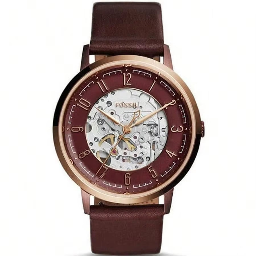 Reloj Fossil ME3131 automático skeleton, caja oro rosa, esfera abierta y correa de piel marrón, maquinaria visible al centro.