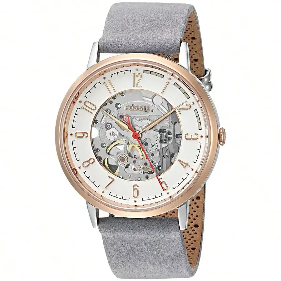 Reloj Fossil ME3131 automático skeleton, caja oro rosa, esfera abierta mostrando el mecanismo, correa gris y visualización en ángulo.