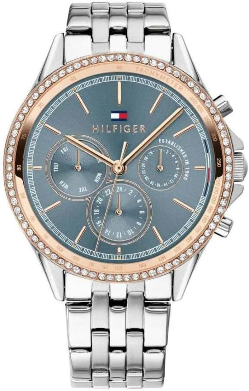 Reloj Tommy Hilfiger para mujer bicolor con bisel de cristales, esfera azul y brazalete de acero inoxidable.