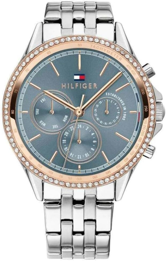 Reloj Tommy Hilfiger para mujer bicolor con bisel de cristales, esfera azul y brazalete de acero inoxidable.