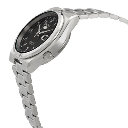 Side profile of the Seiko 5 SNK063J5 automatic watch showing the black Arabic numeral dial, silver-tone case, crown, and stainless steel bracelet.