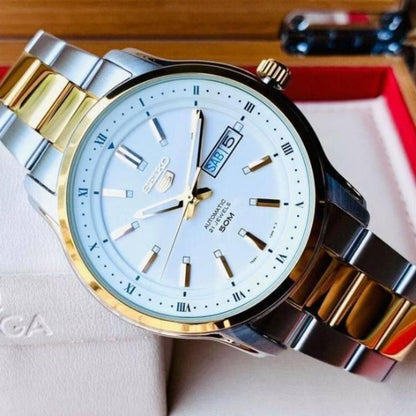 Seiko 5 SNKP14K1 automatic dress watch close-up with white dial, gold-tone accents, day-date display and two-tone stainless steel bracelet.