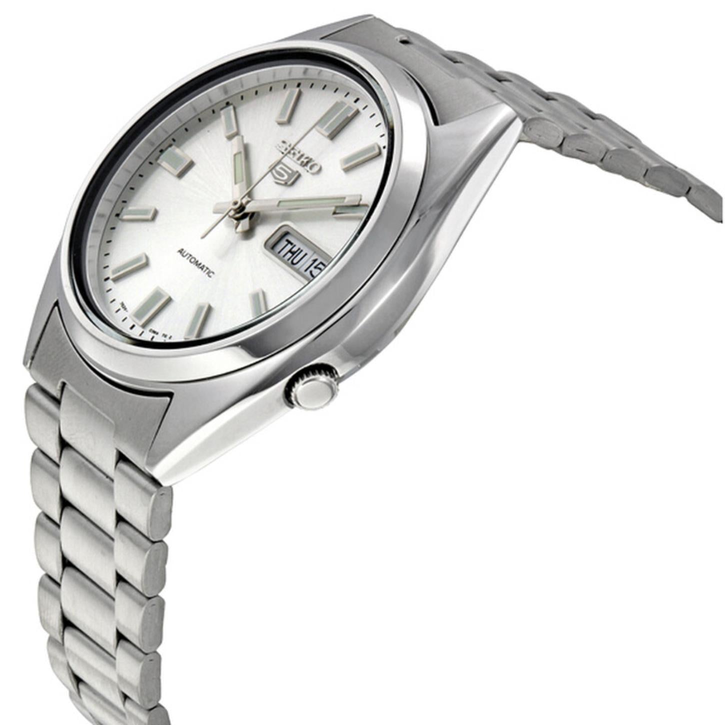 Close angled view of the Seiko 5 SNXS73K1 automatic watch showing the silver dial, day-date display, crown, polished case, and stainless steel bracelet.