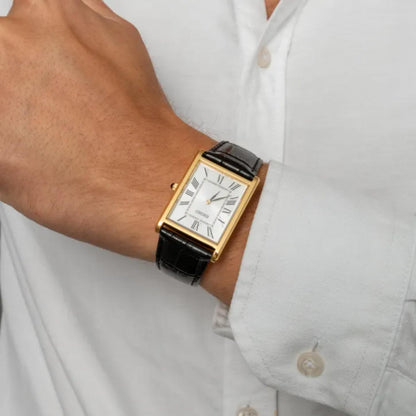 Seiko Classic SWR104P1 worn with a white shirt, featuring a rectangular gold-tone case, white Roman numeral dial, and black leather strap.