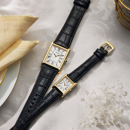 Seiko Classic SWR104P1 rectangular dress watch displayed in an elegant setting with a white Roman numeral dial, gold-tone case, and black leather strap.