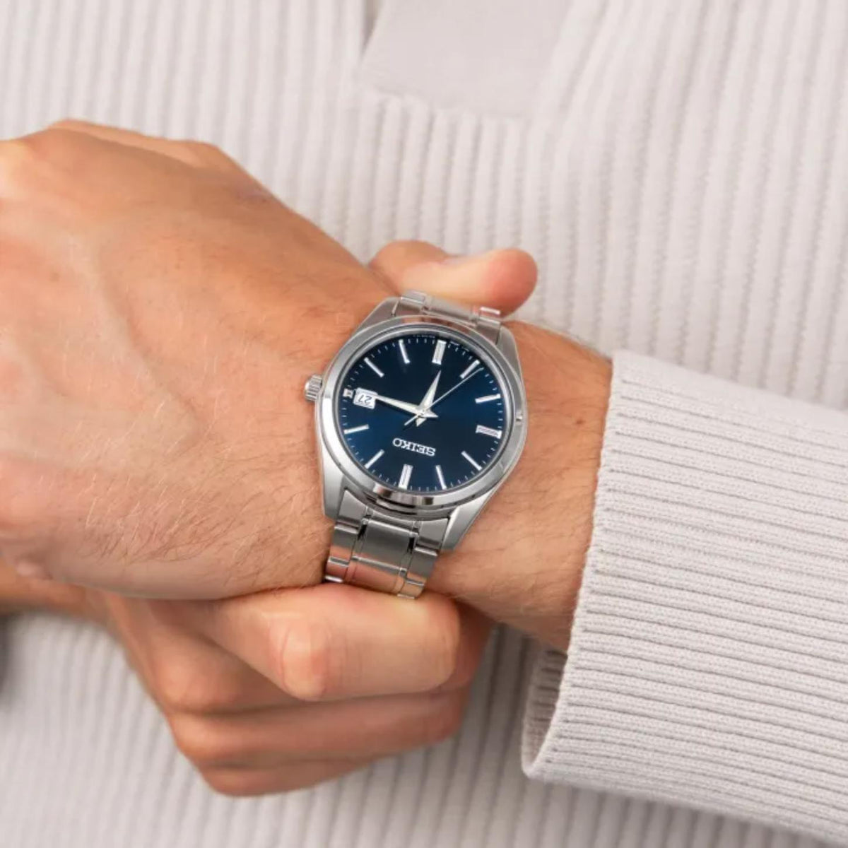 Seiko Essentials SUR399 men's watch featuring a sunburst blue dial and stainless steel construction on wrist
