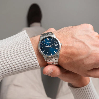 Seiko Essentials SUR399 men's quartz watch worn on wrist with vibrant blue dial and stainless steel bracelet