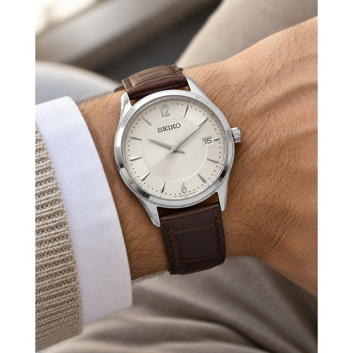 Seiko Noble SUR421 men's quartz watch featuring an antique white textured dial and brown leather strap worn on wrist.