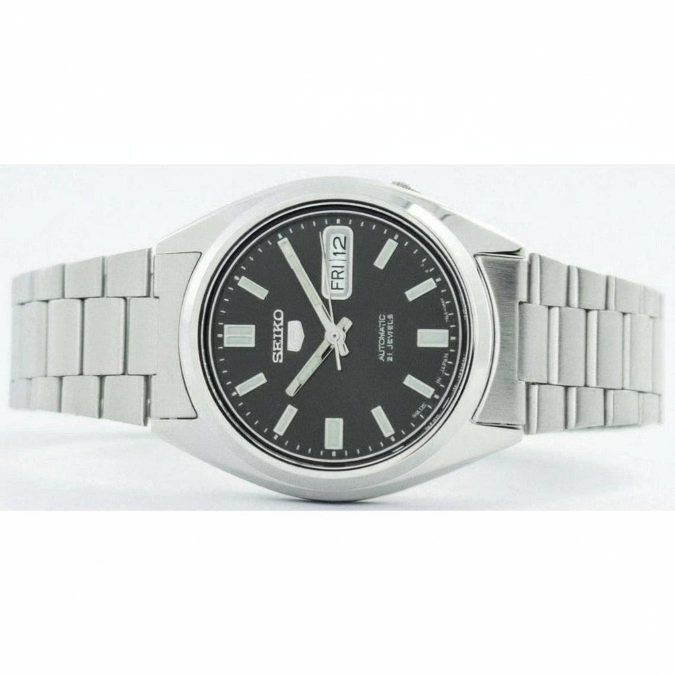 Seiko SNXS79K1 automatic watch with black dial, day-date display and stainless steel bracelet shown from front view.