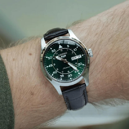 Seiko SRPJ89K1 mens automatic field watch with green dial and brown leather strap worn on wrist in casual style