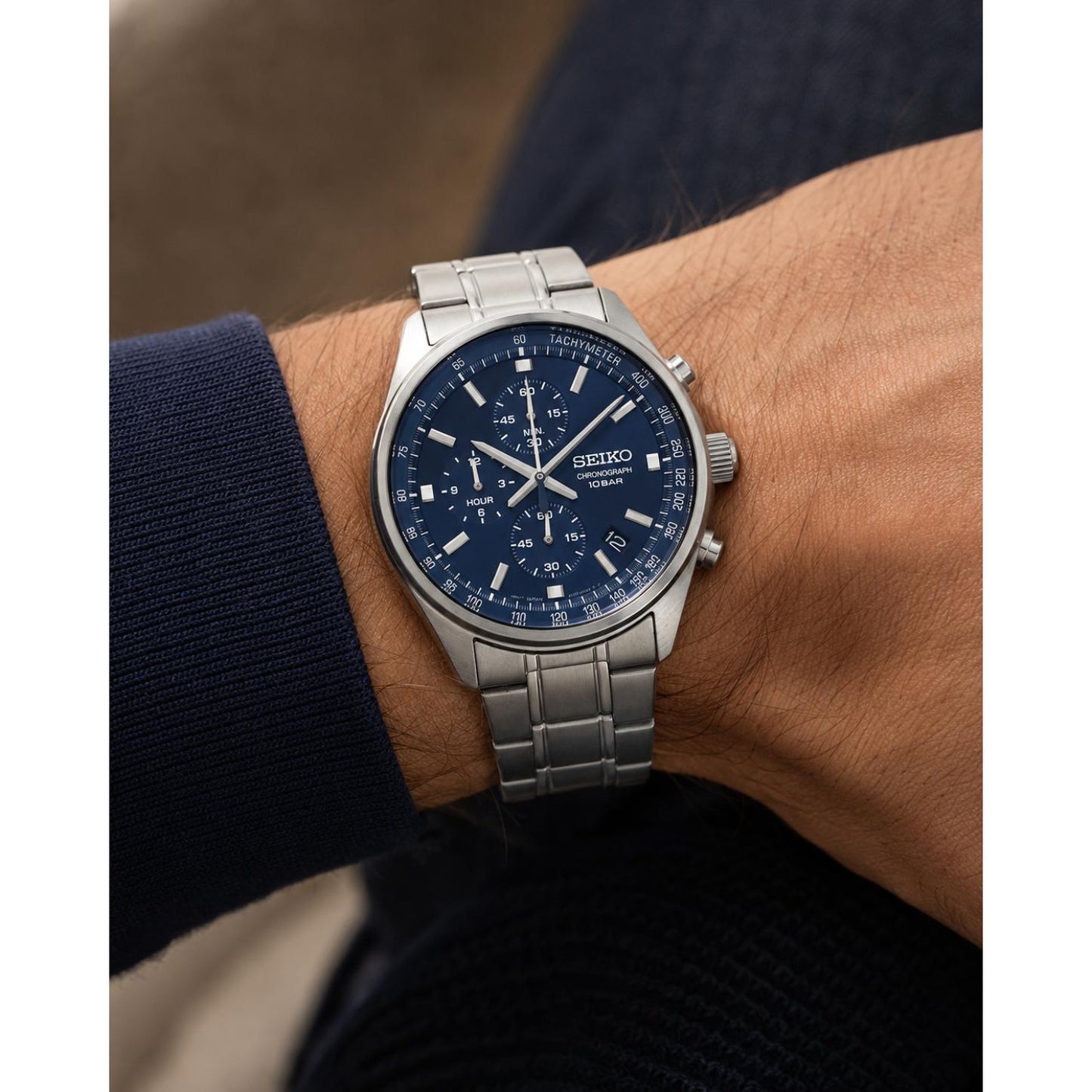 Seiko SSB377P1 sport chronograph worn on the wrist, featuring a blue sunray dial, three chronograph subdials, tachymeter scale, date display, and stainless steel bracelet.